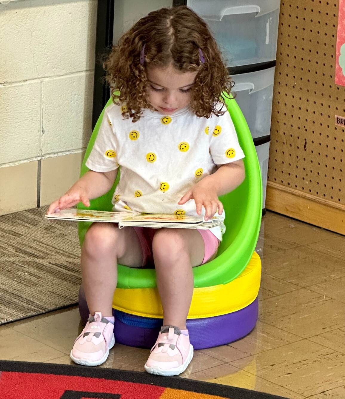 Preschool child looking at a book.